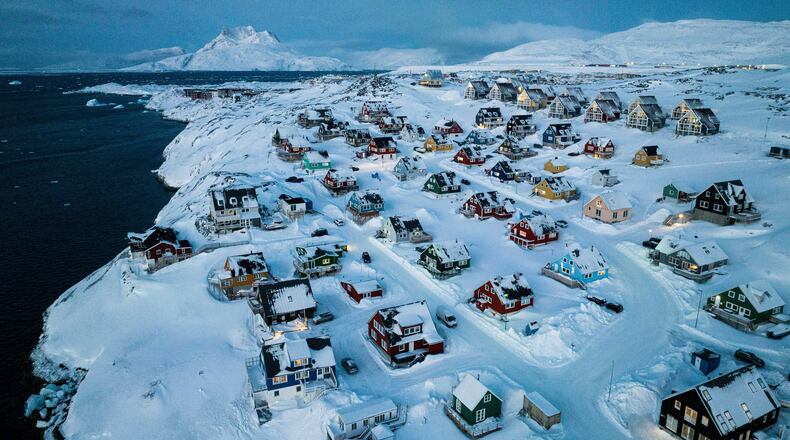 FILE - Houses covered in snow are seen on the coast of a sea inlet of Nuuk, Greenland, Friday, March 7, 2025. (AP Photo/Evgeniy Maloletka, File)