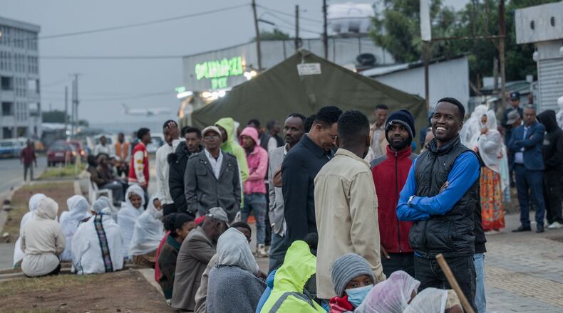 People gather outside a polling station before casting their votes in the general election in Addis Ababa, Ethiopia, Monday, June 1, 2026. (AP Photo/Amanuel Sileshi)