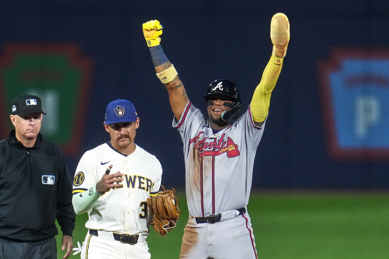 Atlanta Braves' Ronald Acuña Jr., right, celebrates next to Milwaukee Brewers shortstop Joey Ortiz (3) after stealing second base during the fifth inning of the Little League Classic baseball game in Williamsport, Pa., Sunday, Aug. 23, 2026. (AP Photo/Gene J. Puskar)