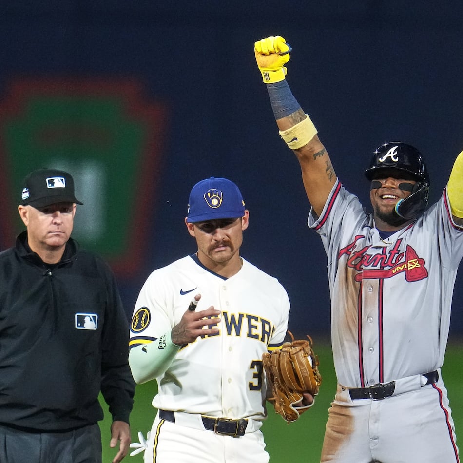 Braves star Ronald Acuña Jr., right, celebrates next to Milwaukee Brewers shortstop Joey Ortiz (3) after stealing second base during the fifth inning of the Little League Classic baseball game in Williamsport, Pa., Sunday, Aug. 23, 2026. (AP Photo/Gene J. Puskar)