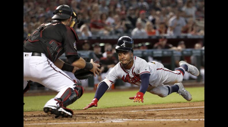 <p>
              Arizona Diamondbacks Nick Ahmed (13) is tagged out at the plate by Atlanta Braves catcher Kurt Suzuki to end the baseball game Saturday, Sept. 8, 2018, in Phoenix. The Braves won 5-4 in 10 innings. (AP Photo/Matt York)
            </p> <p>
              Atlanta Braves catcher Kurt Suzuki celebrates after tagging Arizona Diamondbacks' Nick Ahmed at the plate to end the baseball game Saturday, Sept. 8, 2018, in Phoenix. The Braves won 5-4 in 10 innings. (AP Photo/Matt York)
            </p> <p>
              The Atlanta Braves celebrate after a baseball game against the Arizona Diamondbacks, Saturday, Sept. 8, 2018, in Phoenix. The Braves won 5-4 in 10 innings. (AP Photo/Matt York)
            </p> <p>
              Atlanta Braves' Ozzie Albies is tagged out by Arizona Diamondbacks' Jeff Mathis (2) as he tries to score on a fielders choice hit into by Dansby Swanson during the second inning of a baseball game, Saturday, Sept. 8, 2018, in Phoenix. (AP Photo/Matt York)
            </p> <p>
              Atlanta Braves' Ozzie Albies is tagged out by Arizona Diamondbacks' Jeff Mathis (2) as he tries to score on a fielders choice hit into by Dansby Swanson during the second inning of a baseball game, Saturday, Sept. 8, 2018, in Phoenix. (AP Photo/Matt York)
            </p> <p>
              Arizona Diamondbacks' David Peralta (6) watches a solo home run hit by Atlanta Braves' Kurt Suzuki land in the stands during the eighth inning of a baseball game, Saturday, Sept. 8, 2018, in Phoenix. (AP Photo/Matt York)
            </p> <p>
              Arizona Diamondbacks' David Peralta scores on a double by Daniel Descalso during the eighth inning of a baseball game as Atlanta Braves catcher Kurt Suzuki looks on, Saturday, Sept. 8, 2018, in Phoenix. (AP Photo/Matt York)
            </p>