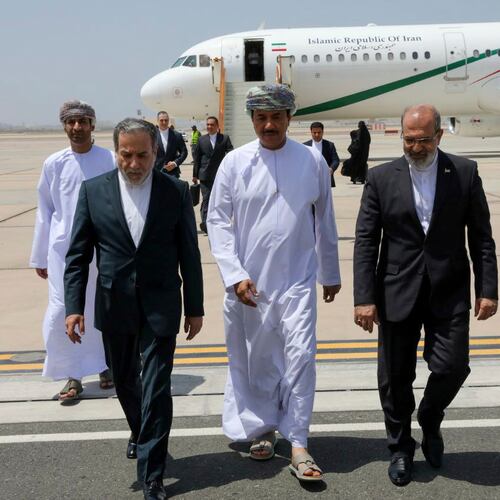 FILE - In this photo released by the Iranian Foreign Ministry, Iranian Foreign Minister Abbas Araghchi, left, is welcomed by an unidentified Omani official, center, upon his arrival at Muscat, Oman, for negotiations with U.S. Mideast envoy Steve Witkoff, as Iranian Ambassador to Oman Mousa Farhang walks at right, May 11, 2025. (Iranian Foreign Ministry via AP, File)