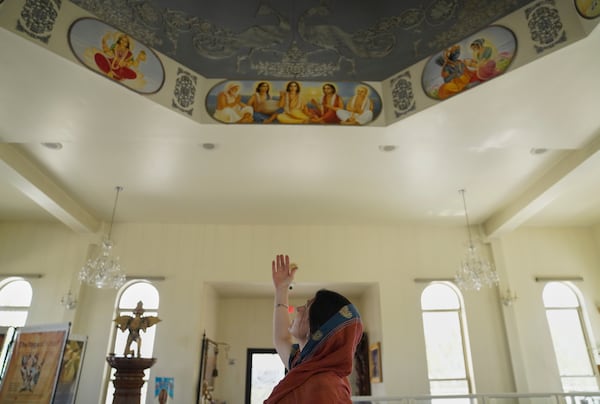 Krishna Presthaya points to the hand-painted ceiling of the Shri Shri Radha Krishna Temple in Spanish Fork, Utah, on Friday, April 25, 2025. (AP Photo/Jessie Wardarski)
