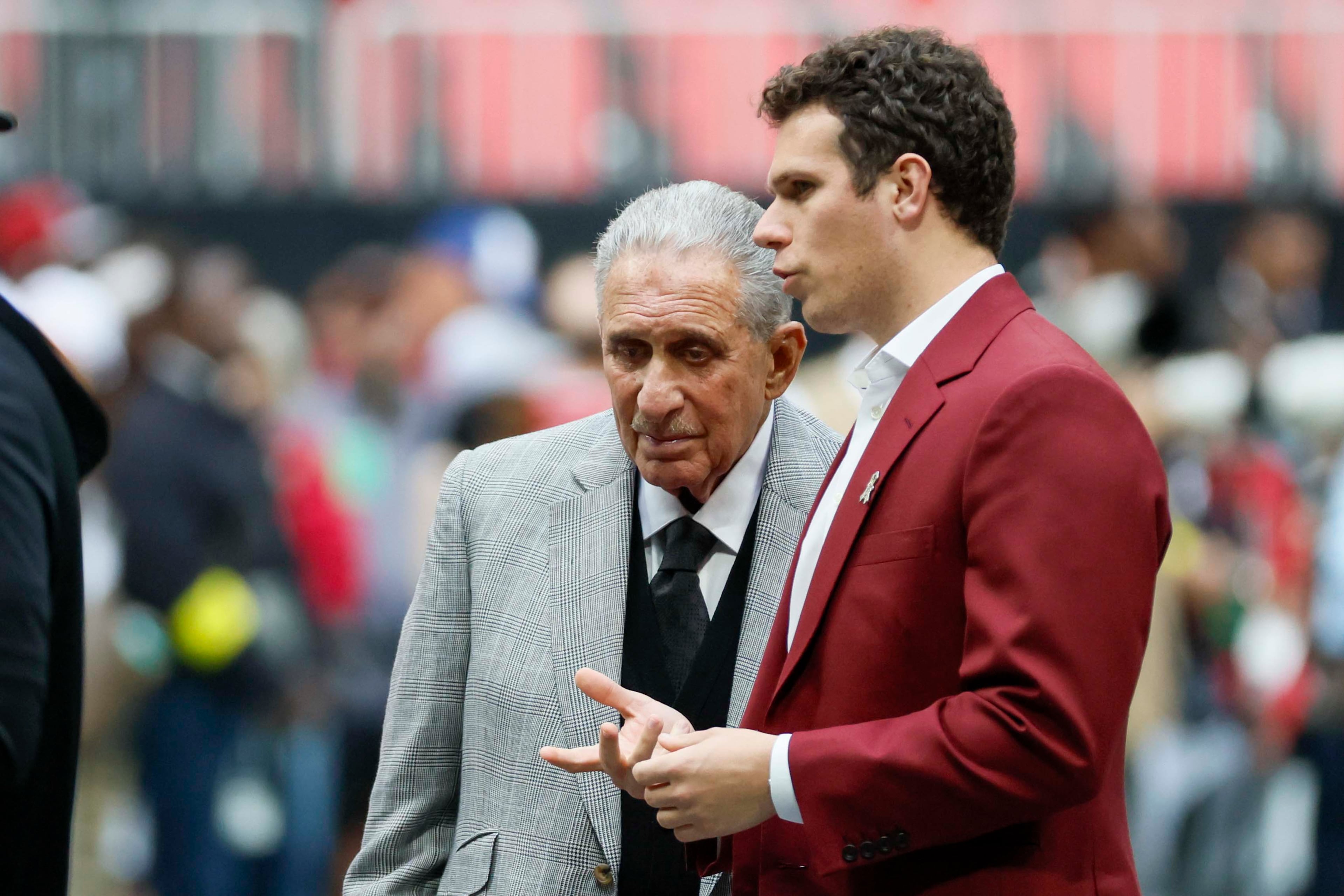 Falcons owner Arthur Blank (left) speaks to his son, Joshua, prior to the team's most recent loss to the Panthers.