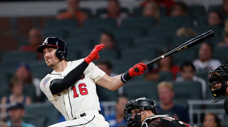 Atlanta Braves pinch hitter Lane Adams (16) follows through on a three-run double in the sixth inning of a baseball game against the Arizona Diamondbacks, Saturday, July 15, 2017, in Atlanta. (AP Photo/John Bazemore)