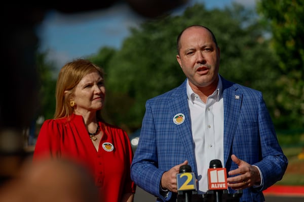 Attorney General Chris Carr and his wife, Joan Carr, speak to the press after voting on the first day of early voting for the primary elections at the Dunwoody Library on Monday, April 27, 2026. (Miguel Martinez/AJC)