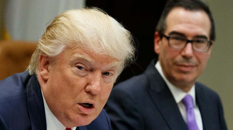 Treasury Secretary Steven Mnuchin listens at right as President Donald Trump speaks during a meeting on the Federal budget, Wednesday, Feb. 22, 2017, in the Roosevelt Room of the White House in Washington. (AP Photo/Evan Vucci)
