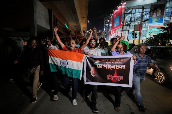 People holding Indian national flags rally's in support of the Indian Army as they celebrate the success of 'Operation Sindoor', in Guwahati, India, Thursday, May 8, 2025. (AP Photo/Anupam Nath)