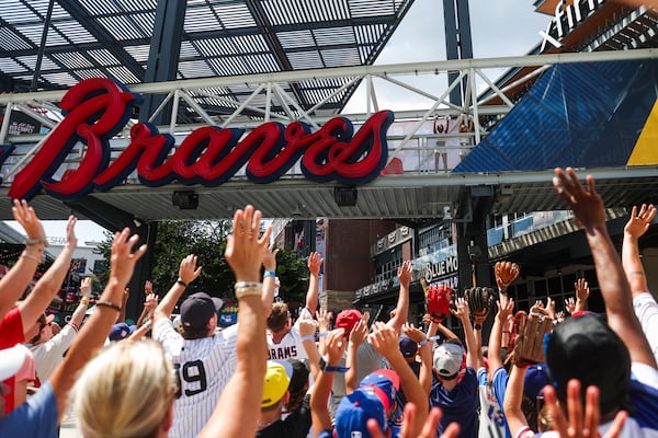 Fans clamor for free rally towels outside Truist Park on Tuesday.