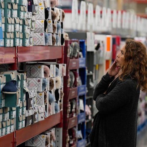 A woman looks at shoes at a Sam's Club, Wednesday, Sept. 24, 2025, in Bentonville, Ark. (AP Photo/Charlie Riedel)
