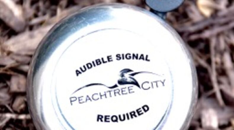 Peachtree City is giving away bells to remind golf cart drivers to use audible warnings when approaching pedestrians. Jill Howard Church for the AJC