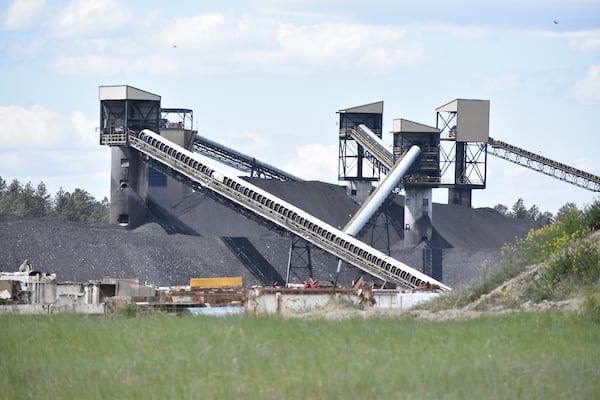 A pile of coal, conveyor belts and towers for moving and storing coal are seen at Signal Peak Energy's Bull Mountains Mine, on May 21, 2025, near Roundup, Montana. (AP Photo/Matthew Brown)
