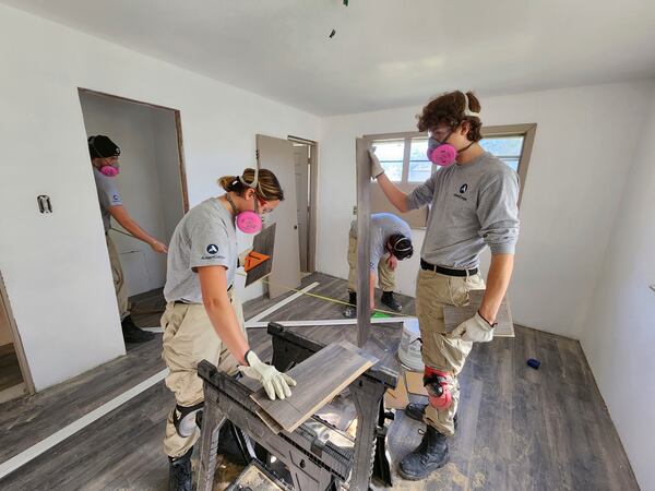 An AmeriCorps team works on home repairs in Brazoria County, Texas, in 2022 with Mosaic in Action, a nonprofit organization that relies on the now-suspended program. (AP via Jim Liberatore)