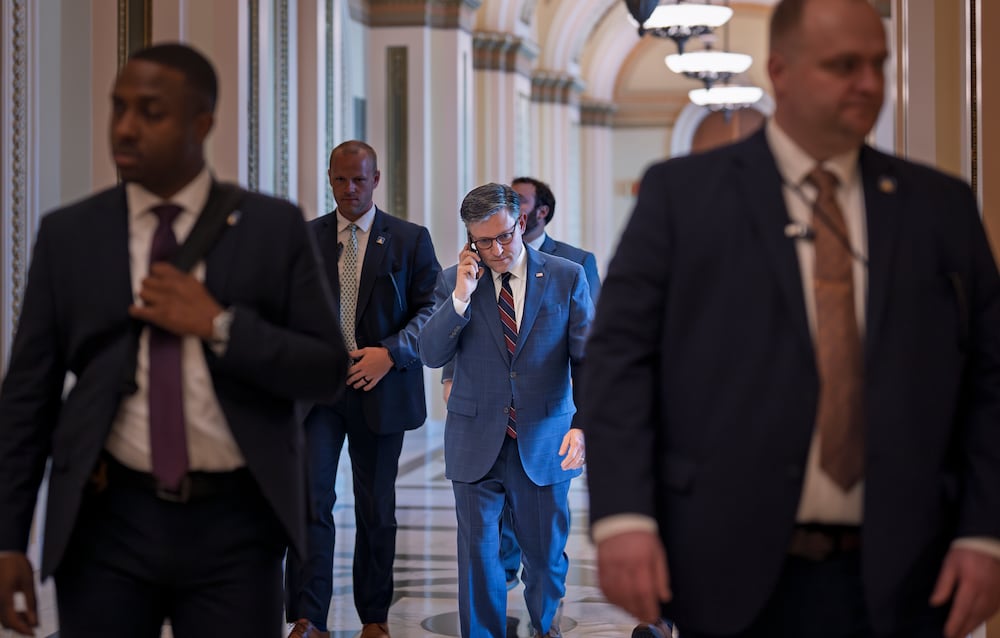House Speaker Mike Johnson (center), R-La., leaves the chamber at the Capitol in Washington, on Thursday.