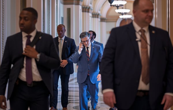 House Speaker Mike Johnson (center), R-La., leaves the chamber at the Capitol in Washington, on Thursday.