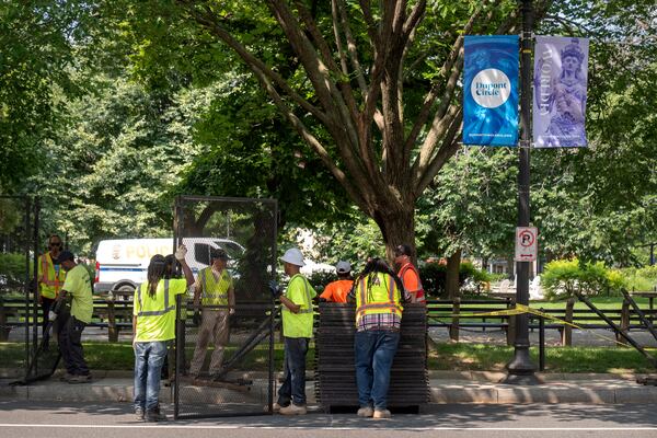 Workers put up fencing around Dupont Circle ahead of the World Pride Parade, Friday, June 6, 2025, in Washington. (AP Photo/Mark Schiefelbein)