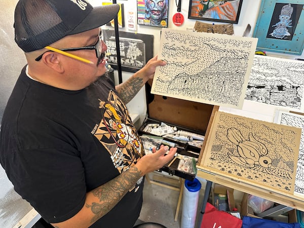Artist Daniel McCoy talks about some of his paintings and sketches while in his studio near Española, N.M., June 13, 2025. (AP Photo/Susan Montoya Bryan)