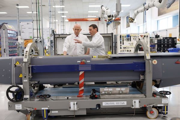 Director of Mechanical Engineering Matt Beamont shows Britain's Defence Secretary John Healey, left, a storm shadow missile on an assembly line at the MBDA Storm Shadow factory in Stevenage, England, Saturday May 31, 2025. (Dan Kitwood/Pool via AP)