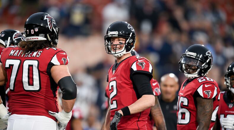 Atlanta Falcons quarterback Matt Ryan, center, warms up with tackle Jake Matthews, left, and running back Tevin Coleman before an NFL football wild-card playoff game against the Los Angeles Rams Saturday, Jan. 6, 2018, in Los Angeles. (AP Photo/Kelvin Kuo)