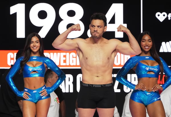 Julio Cesar Chavez Jr., center, poses during a weigh-in ahead of his cruiserweight boxing match against Jake Paul, Friday, June 27, 2025, in Anaheim, Calif. (AP Photo/Chris Pizzello)