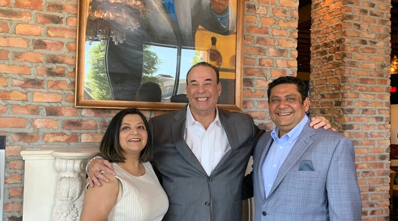 Jon Taffer with Taffer's Tavern franchise partner Gaurav Dhami (right) and his wife Manjari after a ribbon cutting April 13, 2021. RODNEY HO