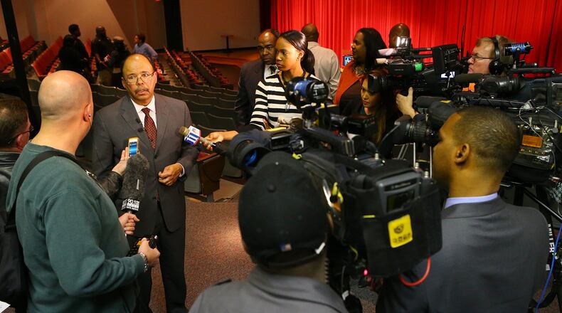 Atlanta Superintendent Erroll Davis is surrounded by news media after a meeting to announce results of an investigation into fraud and football recruiting violations at Grady High School on Wednesday, March 5, 2014, at Grady High School in Atlanta. CURTIS COMPTON / CCOMPTON@AJC.COM