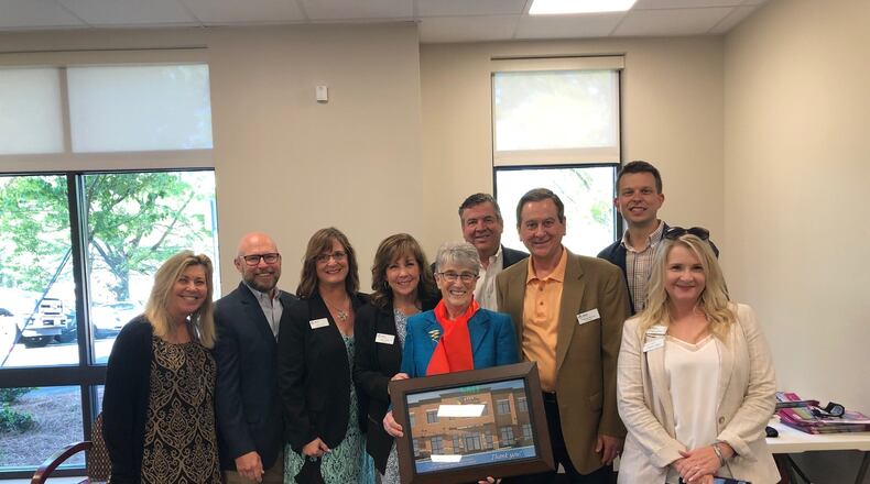 From left: Julie Haley, Bruce Gunning, Holly York, Mary Good, Barbara Duffy, John Carpentier, Bill Brower, Bryan Apinis and Heather Jallad at the opening of the North Fulton Community Charities Duffy Center. (Courtesy North Fulton Community Charities)