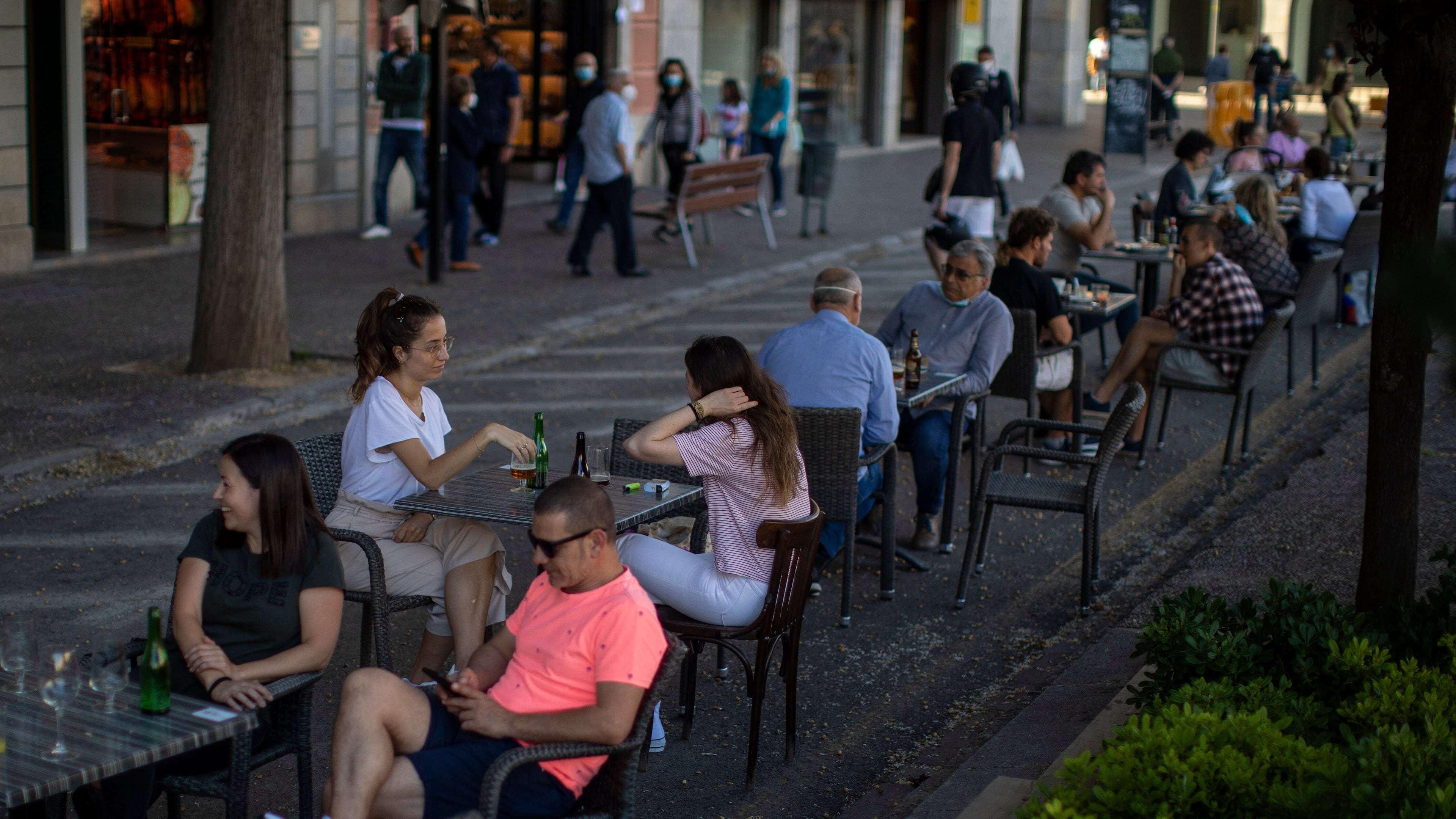FILE - Customers sit at a terrace bar in Girona, Spain, on May 18, 2020. (AP Photo/Emilio Morenatti, File)