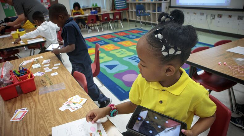 Kailey Gillespie identifies shapes with the help of an iPad during her Mandarin immersion math and science class at Oakley Elementary School. STEVE SCHAEFER / SPECIAL TO THE AJC
