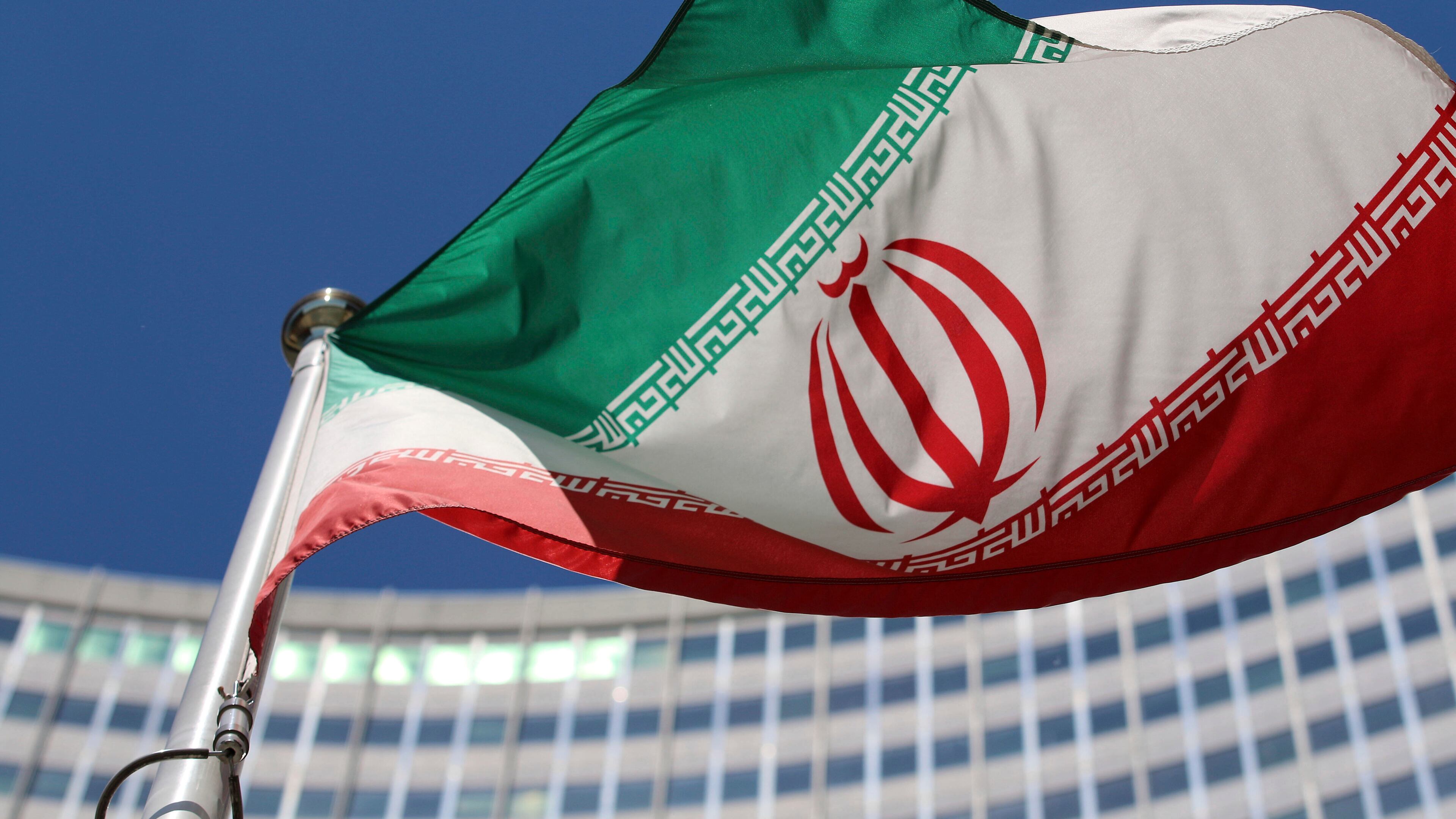 FILE - The Iranian flag flies in front of a U.N. building where closed-door nuclear talks take place at the International Center in Vienna, Austria, on June 18, 2014. (AP Photo/Ronald Zak, File)
