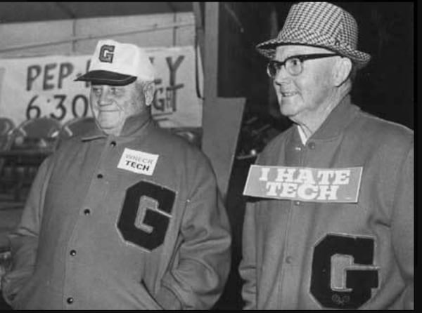 This shot of Bill Hartman (left) with fellow UGA legend Dan Magill (right) is “one of my favorites,” Hartman’s son said. (Hartman family)