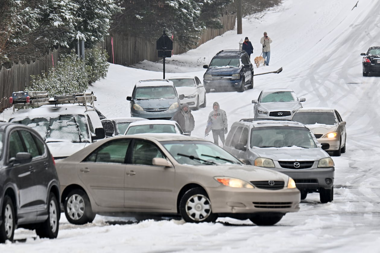 Vehicles get stuck in the snow on Old Snellville Highway on Friday, Jan. 10, 2025, in Lawrenceville. Georgia is bracing for a possibly significant winter storm expected this weekend. (Hyosub Shin/AJC)