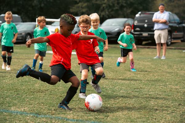 Two boys approach a soccer ball during a game between two of the YMCA's recent boys' soccer teams. (Courtesy of YMCA of Metro Atlanta)