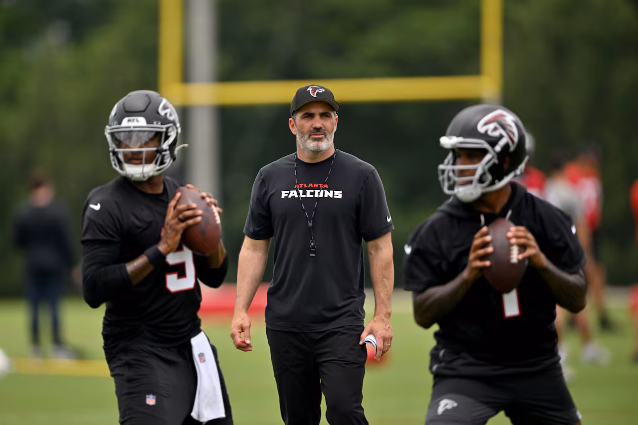 Falcons coach Kevin Stefanski (center) watches as quarterbacks Michael Penix Jr. (left) and Tua Tagovailoa run drills during organized team activities at the Atlanta Falcons Training Facility on Wednesday, May 27, 2026, in Flowery Branch. (Hyosub Shin/AJC)