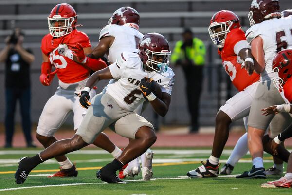 Central (Carrollton) running back Jacez Walton (center) cores a rushing touchdown during the first half against Jonesboro in their GHSA football game at Tara Stadium, Thursday, Sept. 25, 2025, in Jonesboro, Ga. Jacez scored two touchdowns in the game as Central (Carrollton) won 24-21. (Jason Getz/AJC)