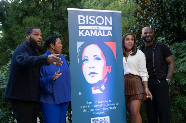 Actor Anthony Anderson (left), a Howard University alumnus who headlined “Bison for Kamala,” stands with others around a poster during the school’s 100th homecoming in Washington, Oct. 19, 2024. Kamala Harris, an alumna of the school, was running for U.S. president at the time. (Cheriss May/The New York Times)