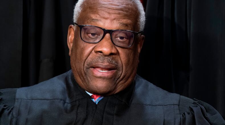 FILE - Supreme Court Associate Justice Clarence Thomas joins other members of the Supreme Court as they pose for a new group portrait, at the Supreme Court building in Washington, Oct. 7, 2022. Thomas was nominated by President George H. W. Bush to succeed Justice Thurgood Marshall and has served since 1991. (AP Photo/J. Scott Applewhite, File)