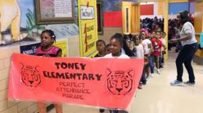 The attendance parade makes its way around the hallways of Toney Elementary in DeKalb County. The school holds a monthly Tiger Pride party to reward students for good behavior and also held a parade for students with perfect attendance. More schools are using such ideas to improve classroom under a framework called Positive Behavioral Intervention and Supports. AJC FILE PHOTO