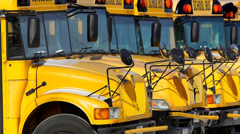 FILE - Public school buses are parked in Springfield, Ill., on Jan. 7, 2015. (AP Photo/Seth Perlman, File)