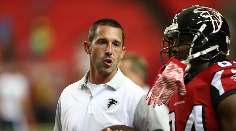 Atlanta Falcons Offensive coordinator Kyle Shanahan, left speaks with wide receiver Roddy White (84) before the first half of an NFL football preseason game between the Atlanta Falcons and the Tennessee Titans, Friday, Aug. 14, 2015, in Atlanta. (AP Photo/John Bazemore)