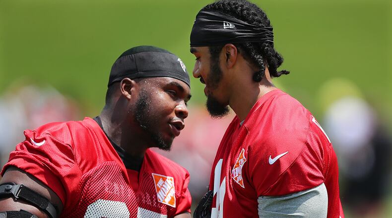 At Falcons minicamp, defensive tackle Grady Jarrett puts a move on his old Clemson teammate, Vic Beasley Jr. (Curtis Compton/ccompton@ajc.com)