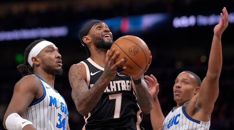 Atlanta Hawks guard Nickeil Alexander-Walker (7) shoots against Orlando Magic guard Desmond Bane (3) during the first half of an NBA basketball game, Monday, March 16, 2026, in Atlanta. (AP Photo/Mike Stewart)