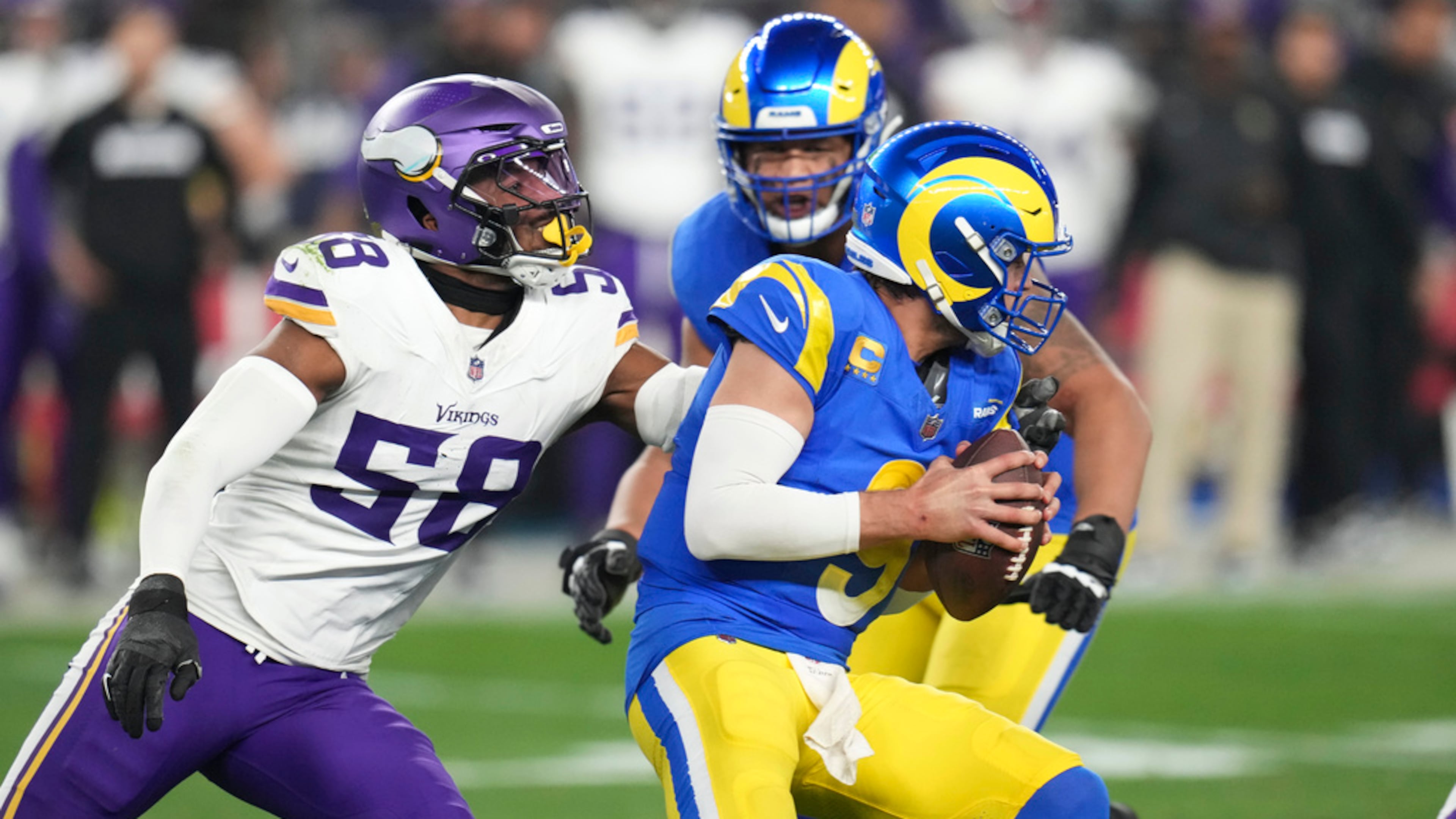 Minnesota Vikings linebacker Jonathan Greenard (left) applies pressure to Los Angeles Rams quarterback Matthew Stafford (right) during the first half of an NFL wild card playoff football game, Jan. 13, 2025, in Glendale, Ariz. (Ross D. Franklin/AP)