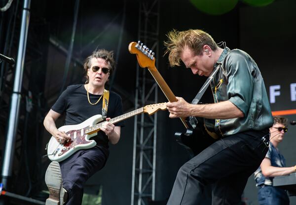 Franz Ferdinand guitarist Dino Bardot (from left) and frontman Alex Kapranos kicked up the energy during the band's Shaky Knees 2025 set in Piedmont Park. (Ryan Fleisher for the AJC)