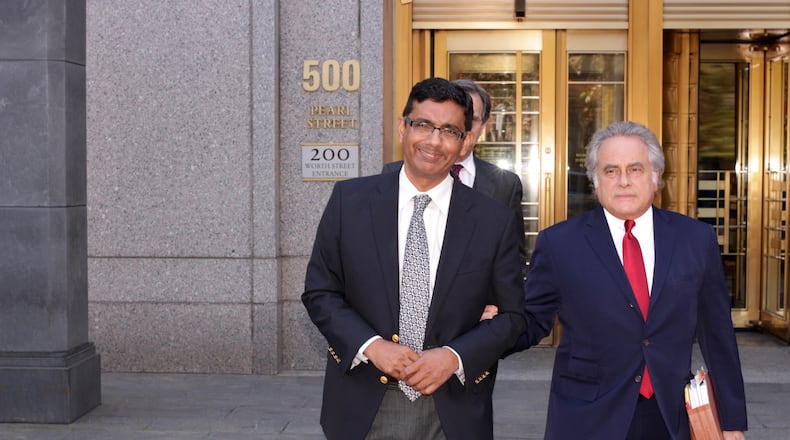 Dinesh D'Souza (left), a conservative commentator and documentarian, is photographed after his sentencing for a campaign finance violation in New York in 2014. Four years later he was issued a pardon by President Donald Trump.