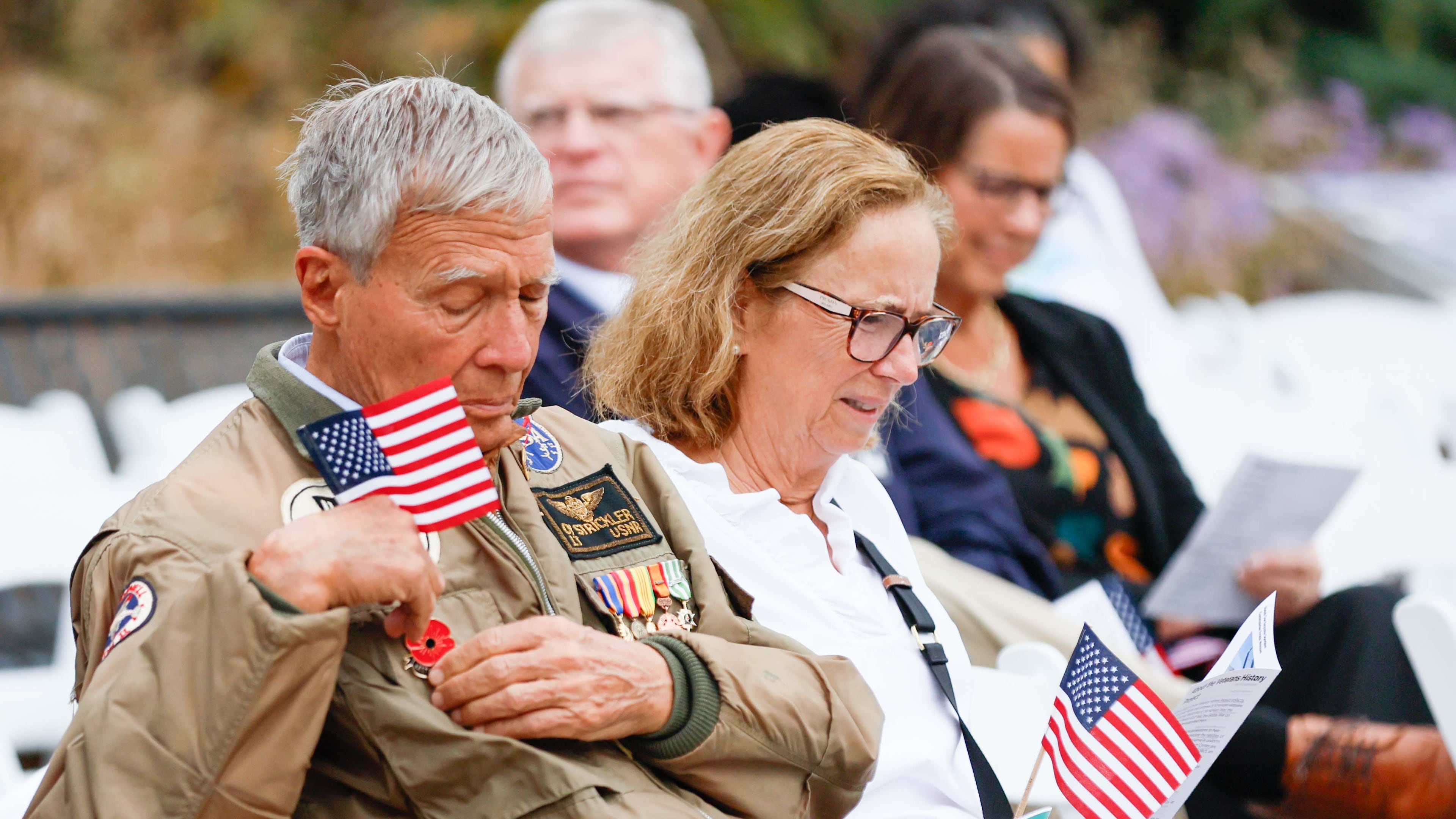 Vietnam veteran Cy Stricker (left) wears an American flag on his jacket at the Veterans Day Commemoration Ceremony at Atlanta History Center on Monday, Nov. 11, 2024, in Atlanta. (Miguel Martinez/AJC 2024)