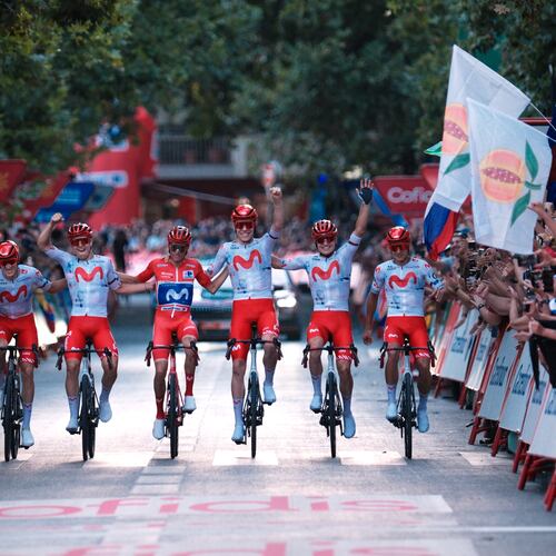 Spain's Enric Mas, center, flanked by his teammates, crosses the finish line during the 21st stage of the Spanish Vuelta cycling race, from Carrefour Granada to Granada, Spain, Sunday, Sept. 13, 2026. (AP Photo/Gregorio Marrero)