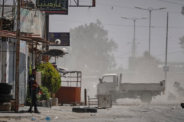 A Druze gunmen stands guard near a checkpoint a day after clashes between members of the minority Druze sect and pro-government fighters left at least four people dead in the southern suburb of Jaramana, Damascus, Syria, Tuesday, April 29, 2025. (AP Photo/Omar Sanadiki)