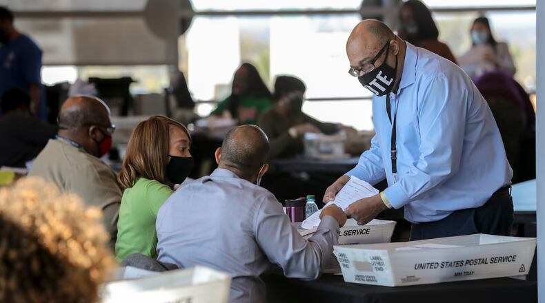 Fulton County election workers started counting and scanning ballots again Wednesday as the state and the nation waited for the results. (John Spink / John.Spink@ajc.com)