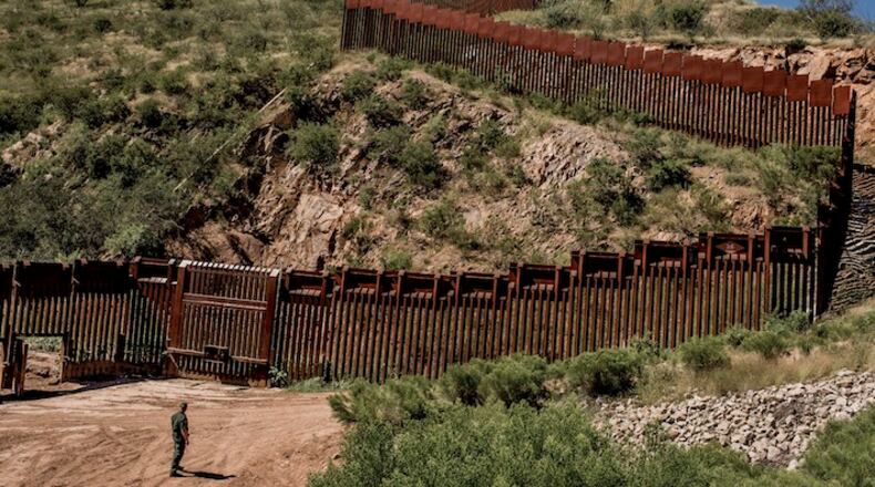 A Border Patrol agent at the fence along the border between United States and Mexico in the outskirts of Nogales, Ariz., Sept. 22, 2016. Clouds have descended over Mexico, miring the nation in a state of anguish and paralysis over what the incoming United States president has in store for it. (Tomas Munita/The New York Times)